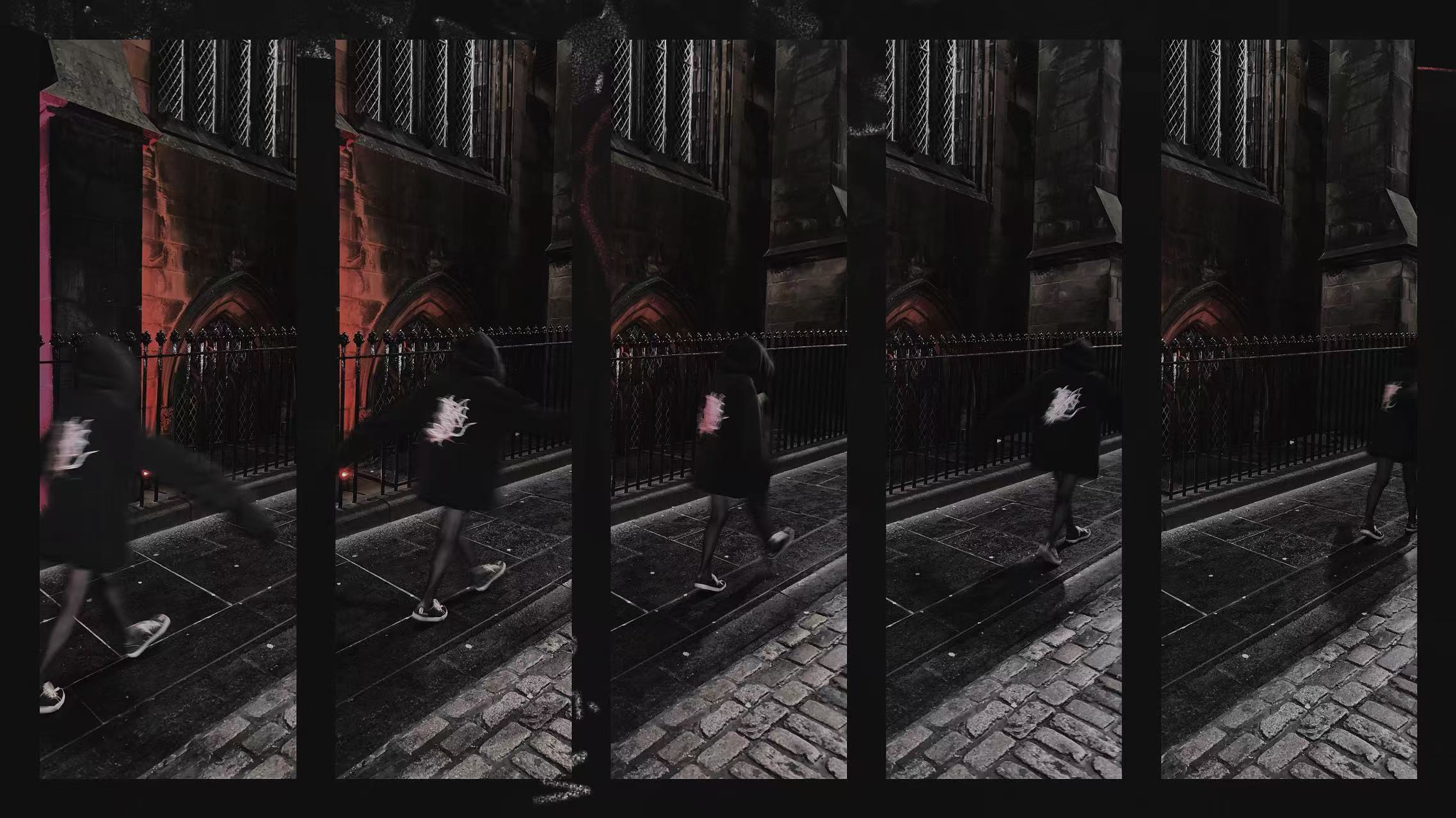 Five side-by-side nighttime frames of a person in a black graphic hoodie walking past stone walls and iron railings.